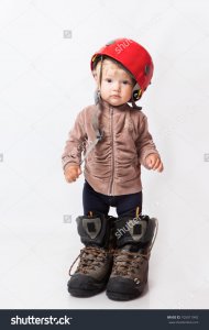 stock-photo-little-girl-in-big-boots-and-helmet-in-studio-105011942.jpg